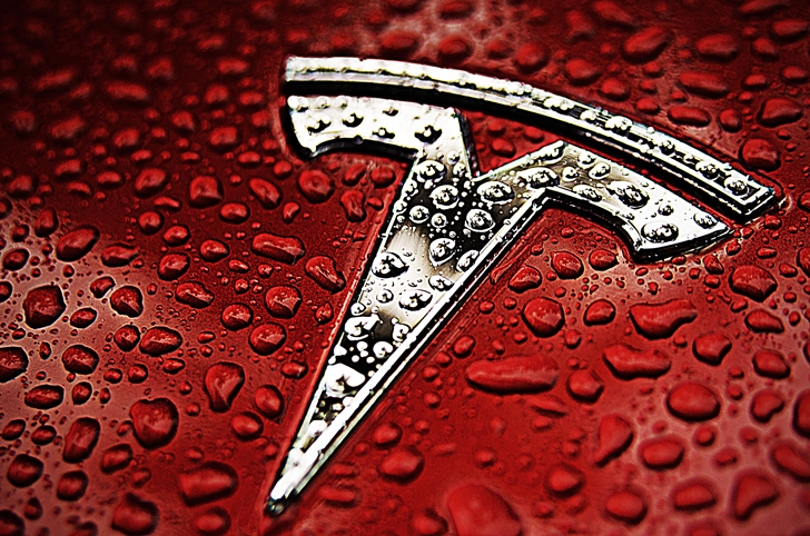 Red-Tesla-Emblem-Logo-Water